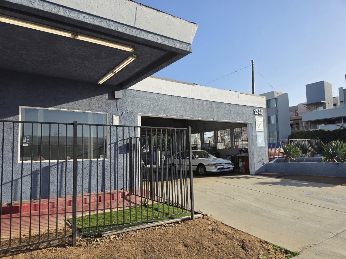 The 1240 Palm Ave building with a sedan in the open test bay