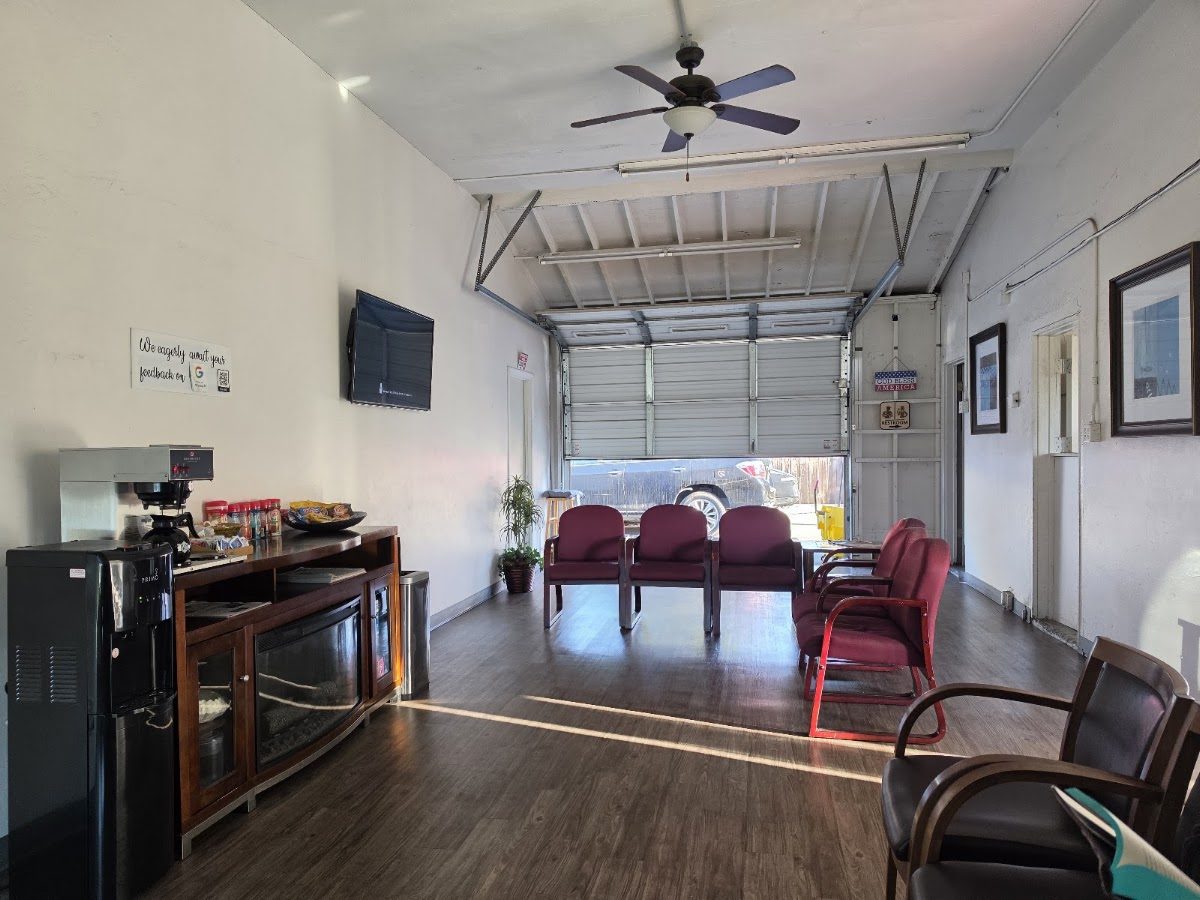 The Easy Breezy Smog waiting room with burgundy chairs, a wall-mounted TV and the coffee and snack console